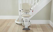 Single rail curves stairlift with wrap-around parking.