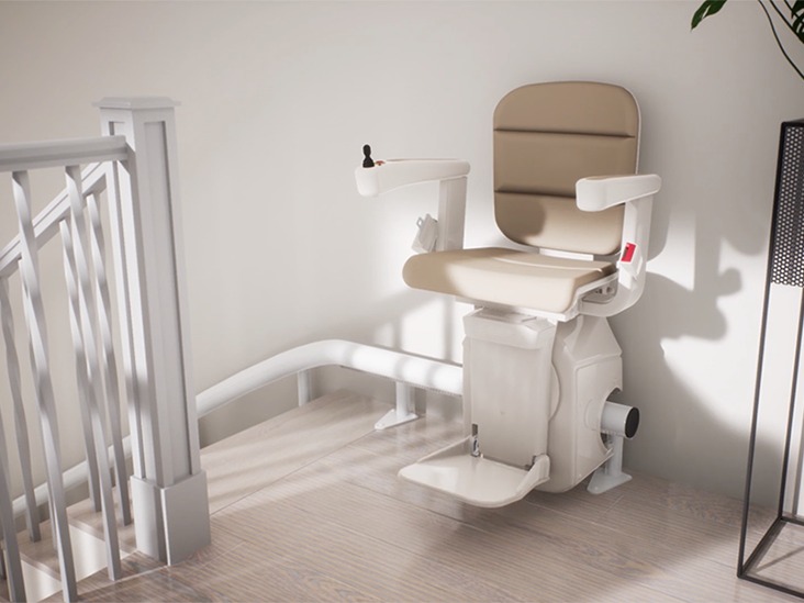 A single track curved stairlift at the top of the stairs with an overrun