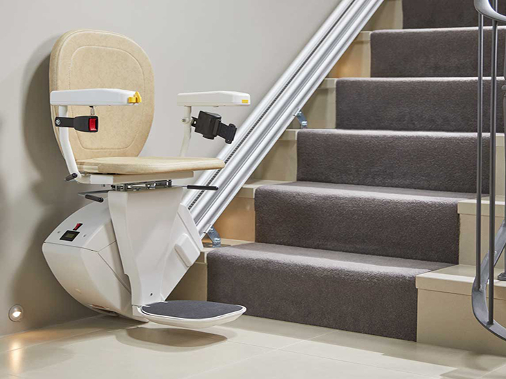 straight stairlift in the opened position at the bottom of a straight stairs