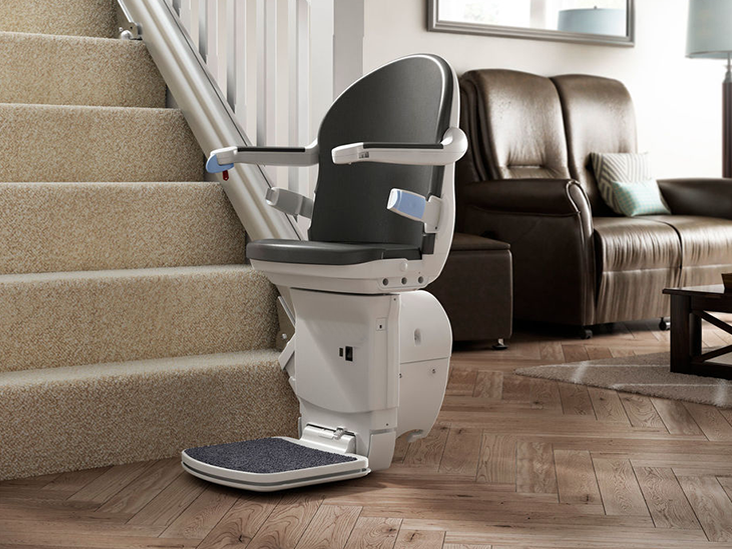 installed on the right side of a straight stairs is an opened straight stairlift